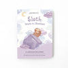 A children's book titled "Slumberkins A Lesson in Caring Board Book Set" featuring a watercolor illustration of a sloth wrapped in a blanket among clouds and stars, with wording that indicates it teaches social-emotional.