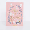 The Collector's Edition of "Alice in Wonderland" features a pink cover with charming illustrations of playing cards, leaves, flowers, a mushroom, Alice, and the White Rabbit holding a watch.