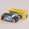A small wooden police SUV in classic American style sits in front of its yellow box, which is labeled “No. 42 GT260 Liberty | Made in England” and shows an illustration matching the toy—perfect for imaginative storytelling adventures.