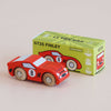 A vintage-inspired red wooden racing car with the number 8 sits next to a green “No. 4 GT25 Finley | Made in England” box, which is decorated with an illustration of the car.