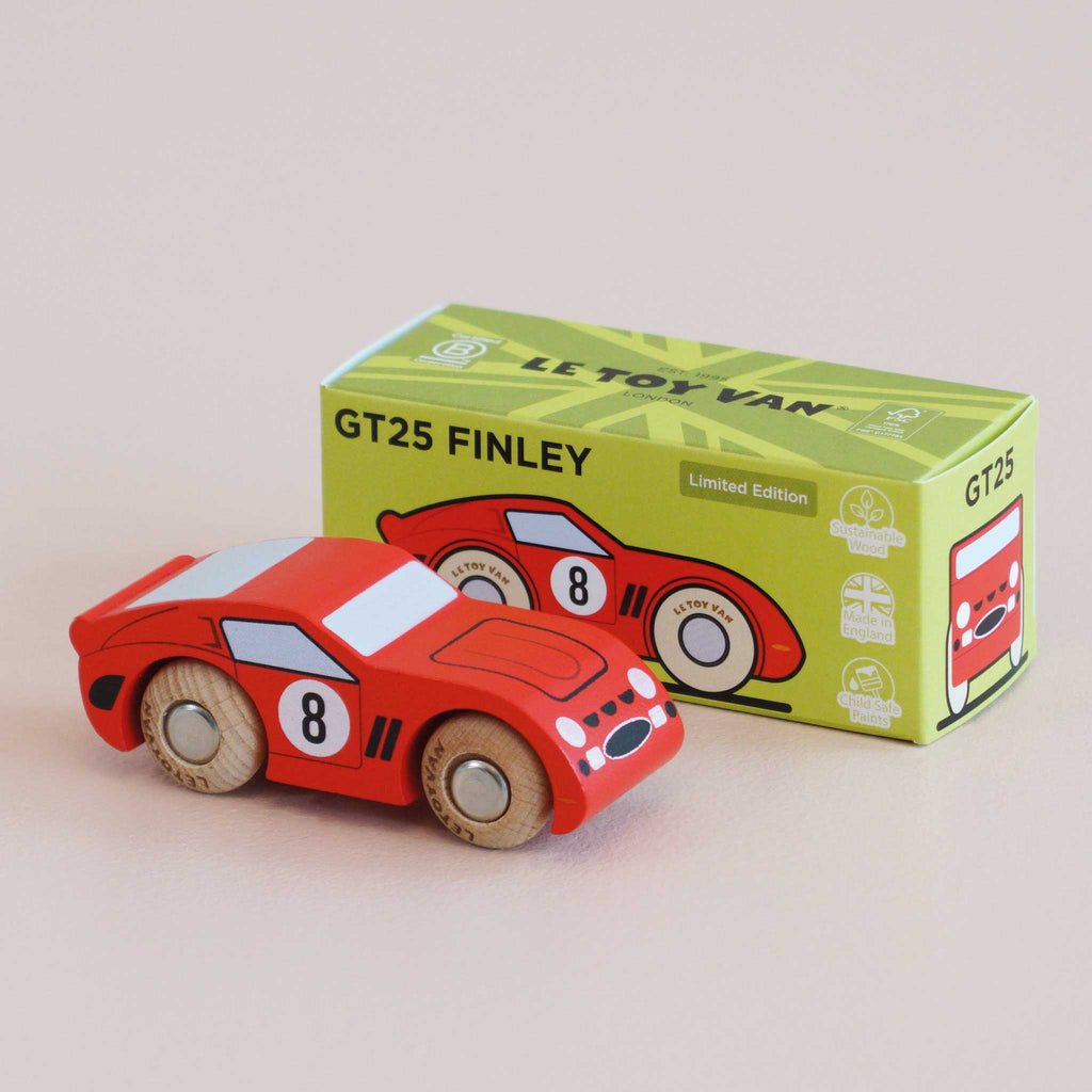 A vintage-inspired red wooden racing car with the number 8 sits next to a green “No. 4 GT25 Finley | Made in England” box, which is decorated with an illustration of the car.