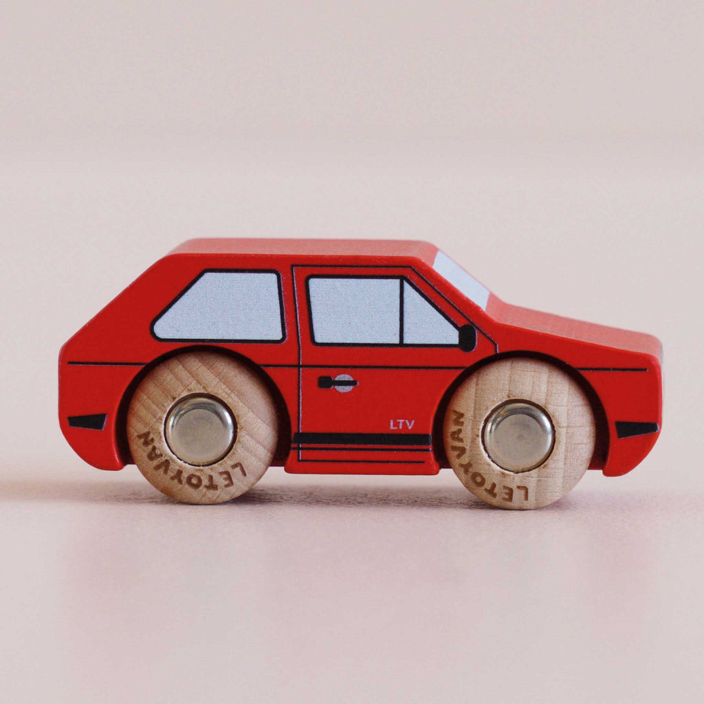 The No. 8 GT50 Gary | Made in England is a small red wooden toy car featuring black and blue detailing with classic wooden wheels, displayed on a light neutral background—its vintage appeal makes it perfect for both collectors and children.