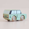 A mint-green wooden No. 28 GT155 Rory toy car, crafted in England, features black window detailing and four light-colored wheels. Photographed on a neutral background, this charming piece of British design inspires imaginative adventure.