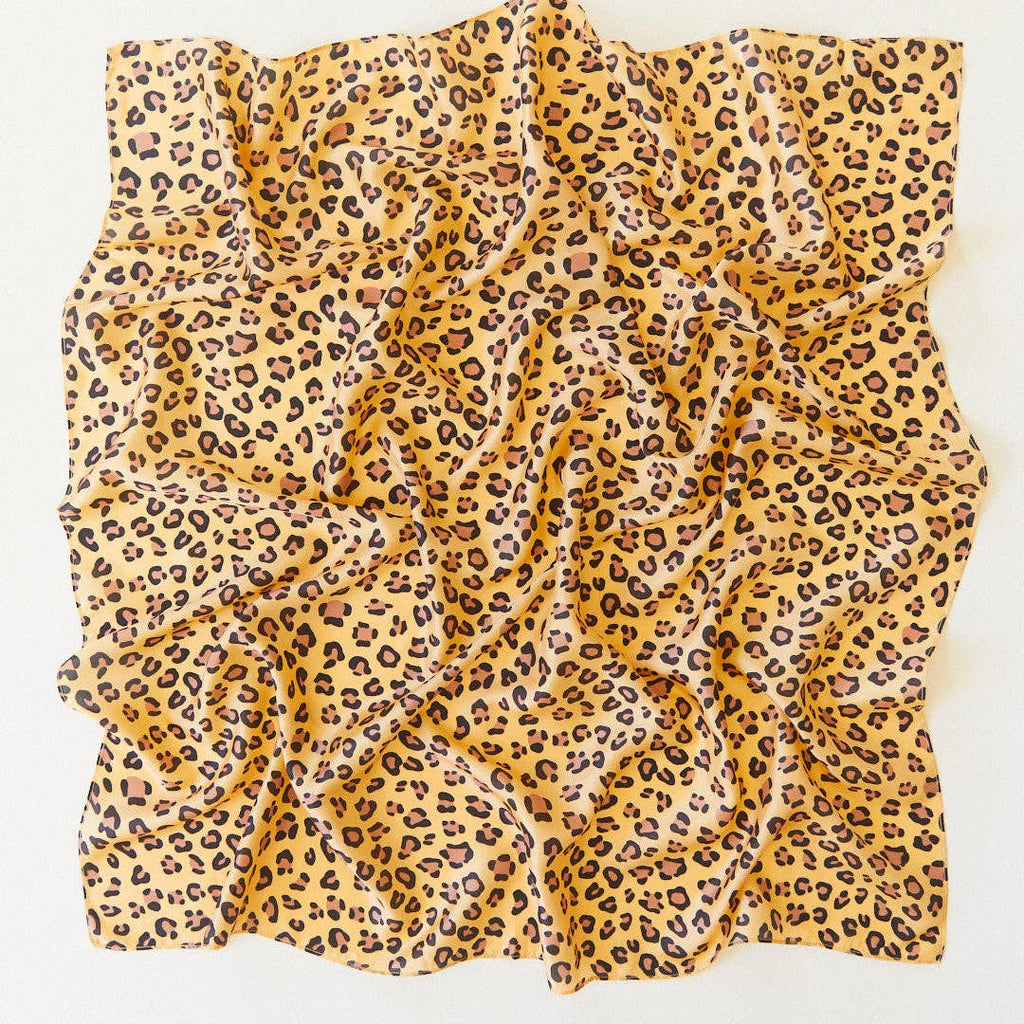 Sarah's Silks Animal Print Playsilk - Cheetah features a square yellow fabric with black and brown cheetah spots, softly folded—ideal for imaginative Waldorf toys play.
