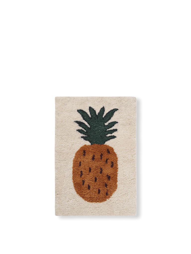 A Ferm Living Fruiticana Tufted Pineapple Rug featuring a stylized design of a pineapple with a detailed brown body and a textured green top on a beige background. The rug, crafted from New Zealand wool, is