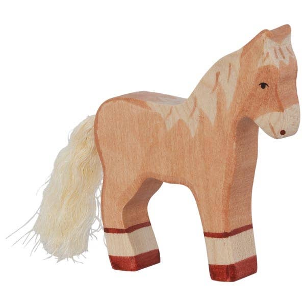 The Holztiger Foal, Standing is a handcrafted wooden toy with a light brown body, dark brown details, white mane and tail, and reddish-brown legs. Made in Europe, it features simple painted facial features like all HOLZTIGER figures.