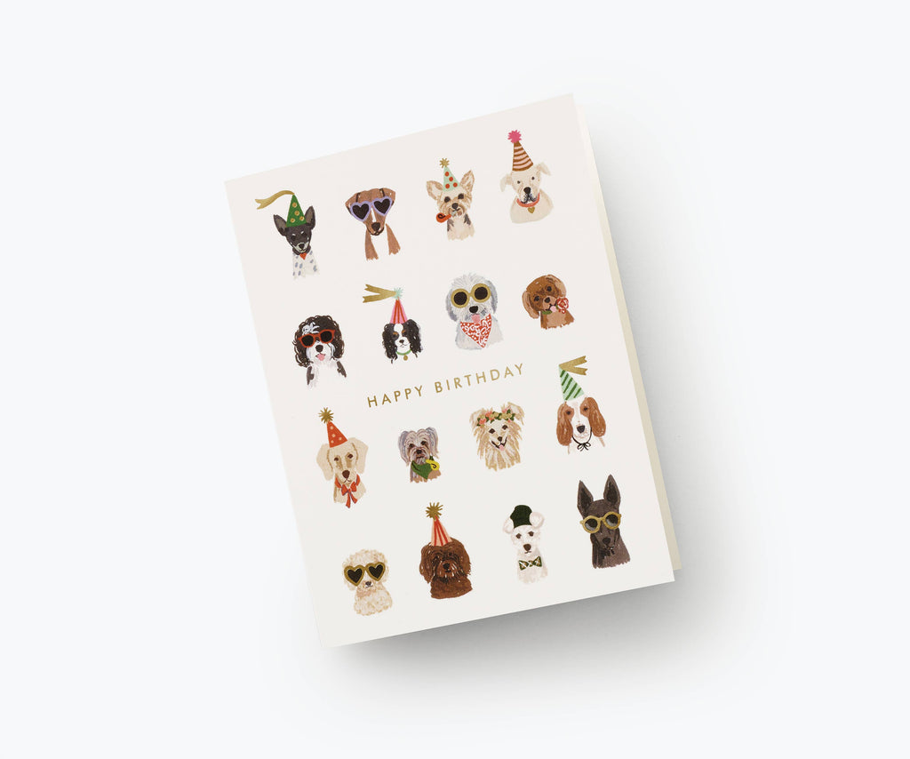 The Party Pups Birthday Card features illustrated dogs in hats, sunglasses, and accessories in a grid above “Happy Birthday” in metallic gold foil on a white background. The card is blank inside for your personal message.
