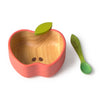 The Pepa the Apple Bowl & Spoon Set is a non-toxic baby dinnerware set featuring a wooden apple-shaped bowl with a green leaf and a matching green stem-like spoon, stylishly displayed on a white background.