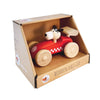 The Wooden Race Car Toy with Dog Driver by Egmont Toys is a charming red sports car, featuring a dog figure as the driver and decorated with white checkered details. It comes displayed in cardboard packaging labeled "WOODEN RACE CAR.