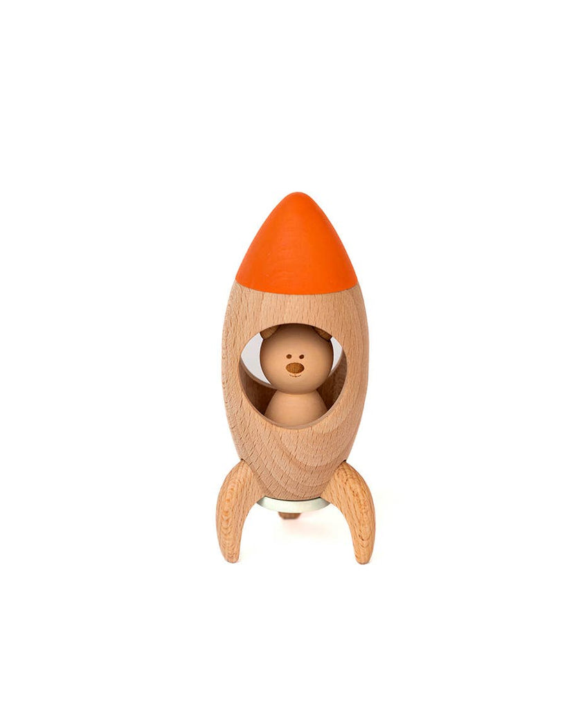 The Sabo Concept Rocket with Bear is a natural wood toy rocket with an orange tip and fins, featuring a small bear inside the open window—ideal for imaginative play.
