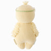 The Cuddle + Kind Baby Duckling (Ivory Floral Crown) is a hand-crafted plush doll viewed from the back, knit from heirloom-quality Peruvian cotton yarn, with textured arms and an ivory floral crown on its head.