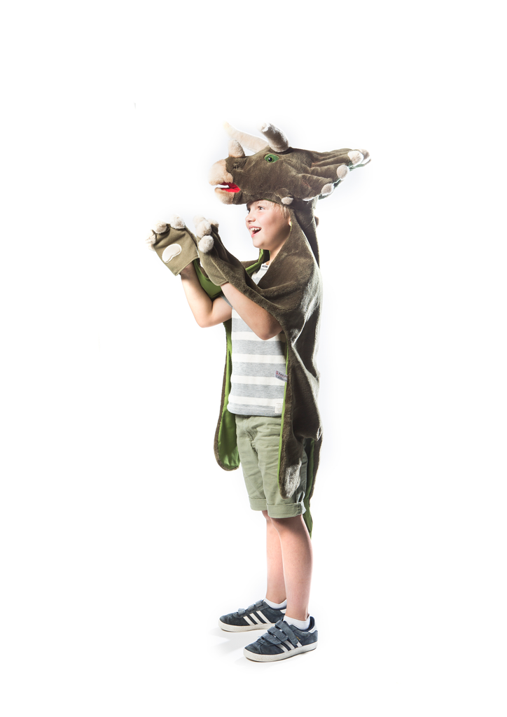 A child smiles against a white background, dressed in the Costume - Triceratops Dino featuring a brown animal suit with a dinosaur hood and faux fur gloves.