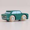 A No. 3 GT20 Tommy, a small green retro wooden car with painted windows and round natural wood wheels, made in England, is shown on a light surface.