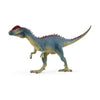 A Schleich Dilophosaurus toy, featuring blue and green coloring with a distinctive red crest on its head, stands upright on two legs facing left against a plain white background—ready to inspire imaginative play about prehistoric giants and the fascinating world of dinosaurs.
