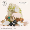 A set of nine wooden Farmyard Stacking Animals arranged in front of a beige drawstring bag. Text reads "9 piece set," "Drawstring bag included," and "Hand Made with Love." A perfect educational gift.