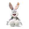 The Steiff Looney Tunes Bugs Bunny plush, featuring gray and white fur, big ears, a pink mouth, and the signature Steiff Button in Ear tag, sits upright against a white background—a perfect collectible for fans.
