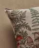 A close-up of the Coral & Tusk Mushrooms and Ferns Lumbar Pillow, featuring green ferns and red mushrooms on a beige fabric background.