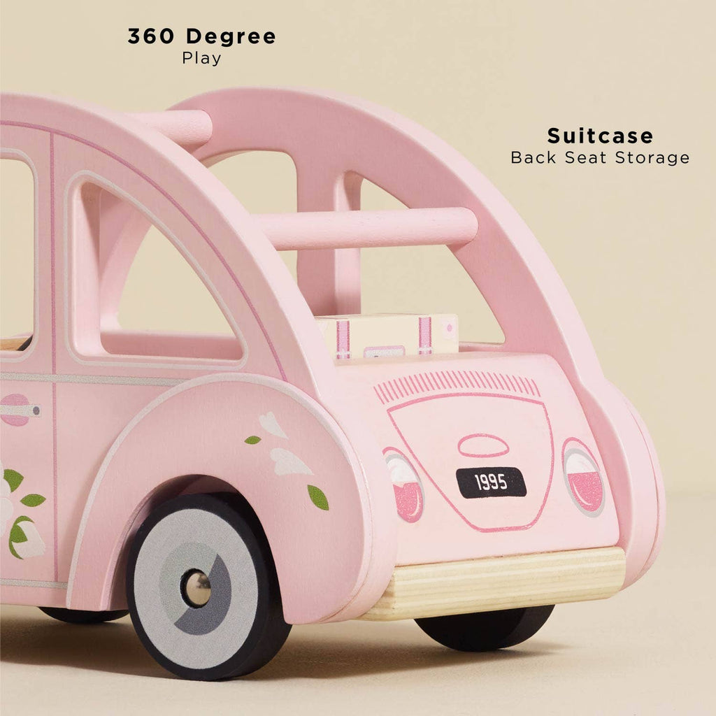 Sophie's Dolls House Toy Car is a retro pink wooden car with floral designs, black wheels, and classic details. It features a removable pink suitcase in the back seat, offering "360 Degree Play" and "Suitcase Back Seat Storage.