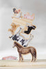 Farm Animals Wooden Puzzle: A Tabitha Paige Puzzle features charming wooden animal figures—including a horse, cow, pig, cat, and chicken—stacked to form a balancing tower on a wooden surface with a plain background. This delightful toddler educational toy is perfect for encouraging fine motor skills and imaginative play.