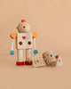 Build -A- Robot, a wooden toy robot with a heart on its chest, stands upright with two interchangeable heads—one smiling and one sad—placed at its feet. Perfect for teaching emotions, the scene is set against a solid beige background.