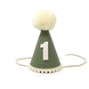 A small Olive Party Hat perfect for birthday celebrations or photo shoots, featuring a white number "1" on the front. The hat is decorated with a white pom-pom at the top and white trim at the base. A beige string is attached for tying. The background is plain white.