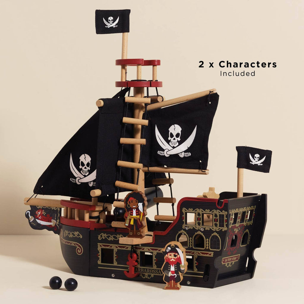 The Barbarossa Pirate Ship & Characters (ships in one week) is an eco-friendly wooden toy with black sails showing white skull and crossbones, two pirate figurines, and two black cannonballs. Text: "2 x Characters Included.