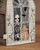 The Coral & Tusk Haunted House Tissue Box Cover features embroidered art of a skeleton, owl, and animal at a window, with bats overhead and vines framing the scene.