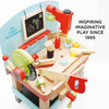 The Wooden Tool Bench is a colorful playset with tools like a saw, hammer, wrench, and screws, plus a chalkboard. Perfect for pretend play. Text: "INSPIRING IMAGINATIVE PLAY SINCE 1995.