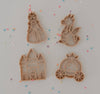 The Princess Cutter Set - Eco Playdough Tool features four eco-friendly cookie cutters in princess, dragon, castle, and carriage shapes arranged on a light surface with colorful star-shaped sprinkles scattered around them. These charming utensils are perfect additions to any biodegradable playdough set, doubling as delightful princess-themed playdough tools.