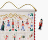 Nutcracker Embroidered Hanging Advent Calendar - Red featuring embroidered nutcracker characters and holiday motifs, with a separate nutcracker figurine to place in the numbered pockets.