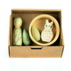 A small cardboard box contains the Hello Winter Set (Grapat X Ostheimer Limited Edition): a vine-painted figure, two green shapes, a bowl, and a white owl with green eyes and markings.