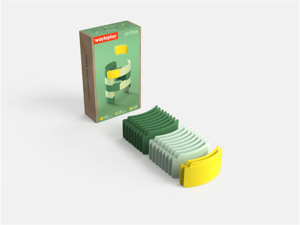Curved green, gray, and yellow toy track pieces from the WaytoPlay: Arches - Starter Set are arranged on a white surface next to a box labeled “waytoplay arches.” The box displays an image of the arches stacked vertically, highlighting this creative construction toy.