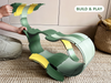 A child’s hands assemble a curved green and yellow plastic structure—the WaytoPlay: Arches - Builder Set—on a woven rug. A wicker basket sits nearby. The words “BUILD & PLAY” appear in the top right corner.
