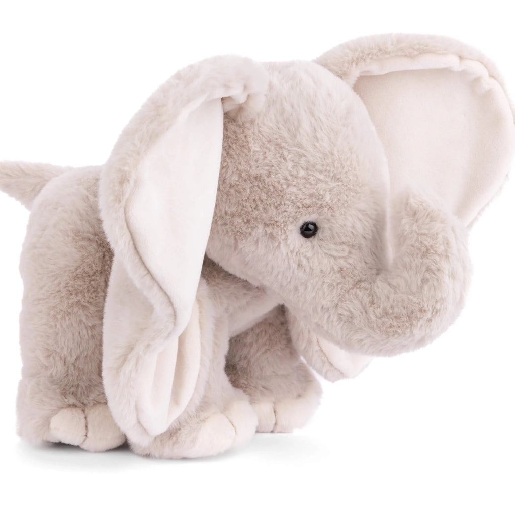 The Bukowski - August Elephant is a huggable plush toy featuring soft, light gray fur, large floppy ears, a curved trunk, and black button eyes. Standing on all four legs against a white background, it’s perfect for bedtime snuggles.