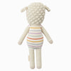 Cuddle + Kind Avery the Lamb is a hand-knit plush doll featuring textured cream wool, floppy ears, and a striped pastel romper. Made from 100% cotton yarn, it's shown from the back against a plain white background.