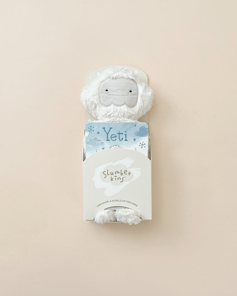 A Slumberkins Yeti Kin + Lesson Book in a packaging labeled "yeti king - mindfulness buddies - discover a world of friends" against a light beige background.