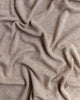 Close-up of a Handmade Merino Wool Bibi Blanket - Sand with small, regular bumps and gentle, undulating folds.