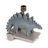 A whimsical gray Dinosaur Birthday Train With Beeswax Candles, featuring a stegosaurus on wheels with a golden candle cup on its back, set on a rectangular base with a small pull handle.