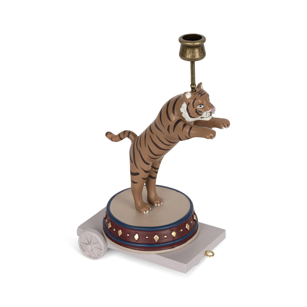 A candle holder shaped like a standing tiger on a decorative base with wheels, designed for the Magical Forest Birthday Train With Beeswax Candles. The candle cup sits above the tiger's head, making it a charming addition to your birthday train set.