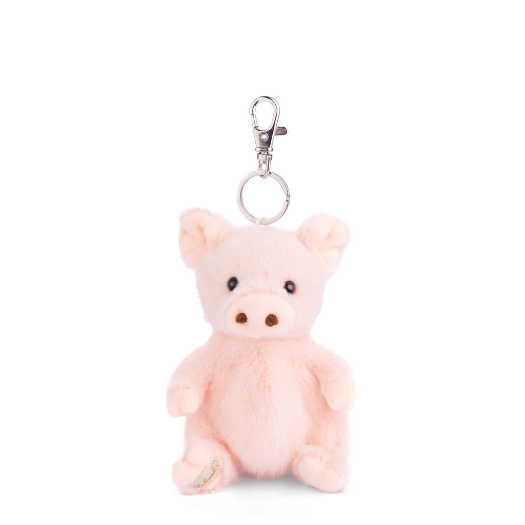 The Bukowski - Baby Oink Pig Bag Charm is an adorable plush pink pig keychain featuring black eyes, a round snout, and a silver clip attachment on top—making it the perfect playful accessory to add to your favorite bag or backpack.