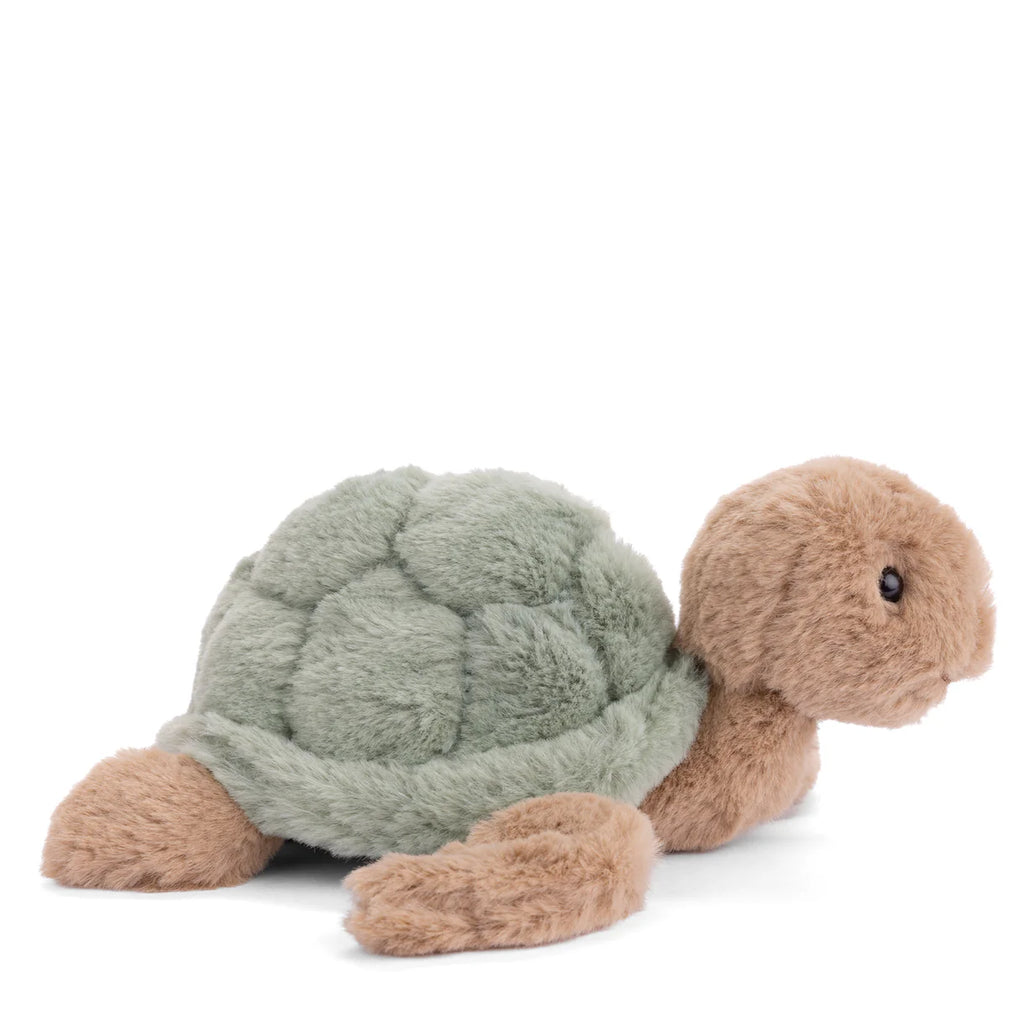 The Bukowski Baby Sandy Sea Turtle is a plush toy with a soft green shell and light brown head, legs, and tail, shown against a white background.