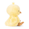 The Bukowski - Baby Chicky plush toy is a soft, yellow chick that sits upright facing to the right, displaying its side profile. It features a small brown beak and feet, as well as tiny wings on its sides. The background is plain white.