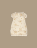 The Maileg Little Sister Bedroom Set features a cream-colored, short-sleeved doll dress with a light brown and yellow floral pattern—ideal as a charming nightgown or to mix and match with other Maileg mouse accessories.