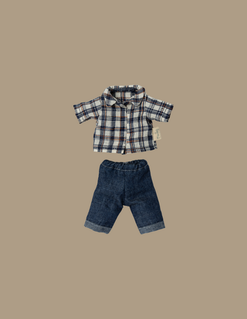 Elevate your mouse collection with the Maileg Extra Clothing: Clothes For Dad Mouse, featuring a delightful outfit that includes a blue, white, and red plaid shirt adorned with short sleeves and buttons. Paired perfectly with dark blue denim jeans complete with stylishly folded cuffs, this charming clothing set is artfully displayed on a plain beige background.