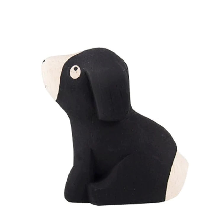 A small, black and white Handmade Tiny Wooden Beagle Dog figurine with abstract and minimalist features, isolated on a white background.
