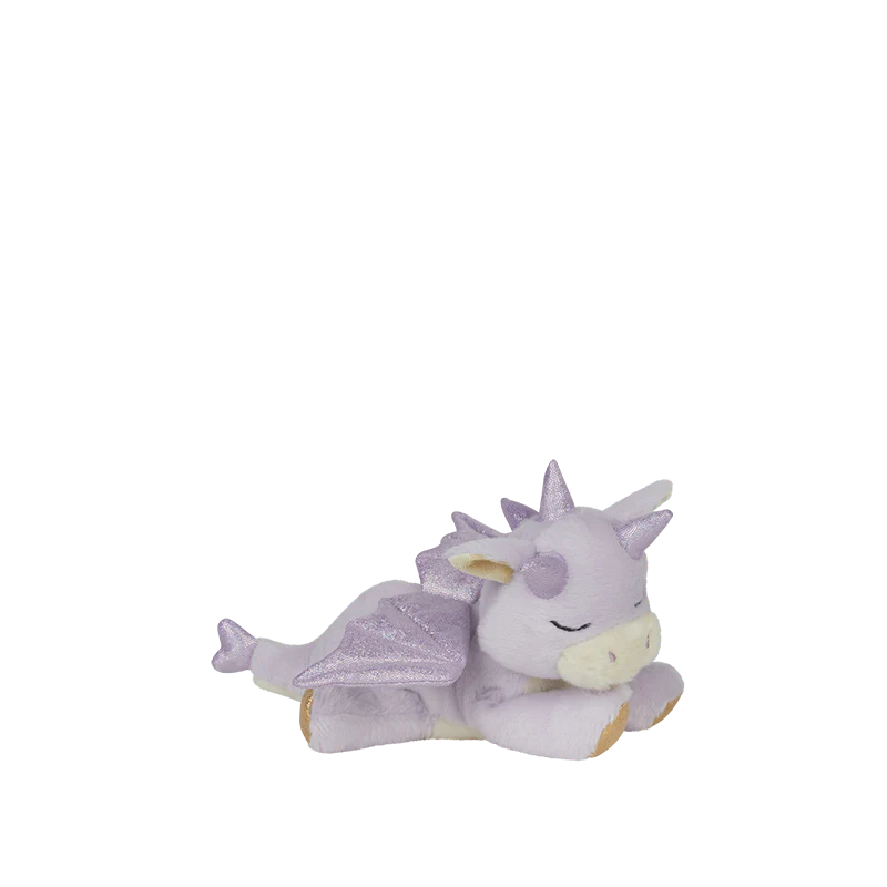 The Olli Ella Binky Dragon - Misty - Lavender is a small, plush lavender cuddly toy with closed eyes, sparkly wings, and soft spikes, shown lying on its stomach against a plain white background.