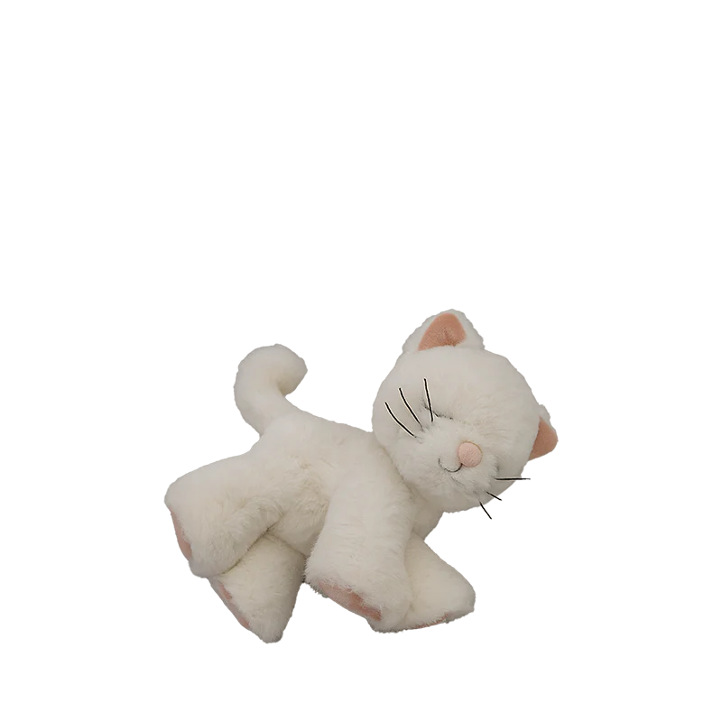 The Olli Ella Binky Kitten Kiki - White is a soft, white plush cat with a smiling face, closed eyes, pink details, and a curved tail—perfect for cuddling and snuggling. Shown against a plain white background.