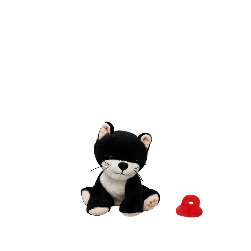 The Olli Ella Binky Kitten Kit - Black & White, featuring a black and white kitten plush with closed eyes, sits beside a small red cuddly toy on a plain white background.