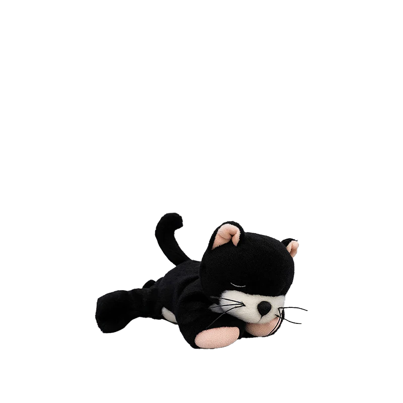 The Olli Ella Binky Kitten Kit - Black & White is a cuddly plush toy featuring a black and white kitten lying down with closed eyes, front legs stretched forward, and its tail curved up on a plain white background.