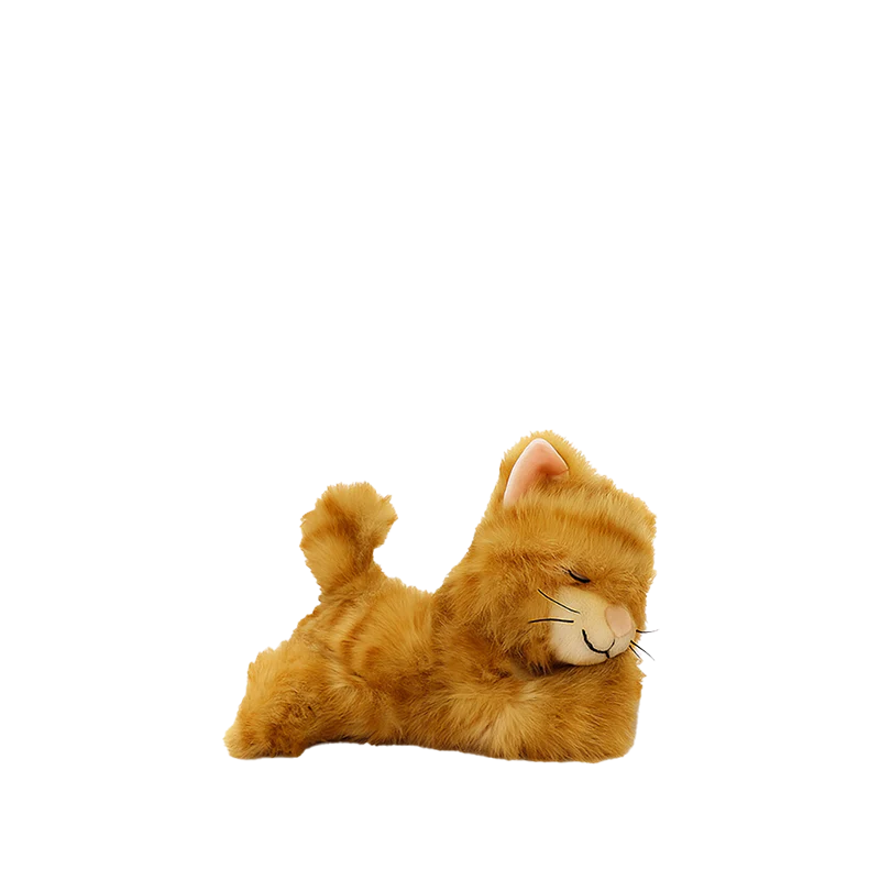 The Olli Ella Binky Kitten Koda - Ginger is a plush kitten with orange fur and closed eyes, lying on its side with a curled tail, resembling a cuddly stuffed animal against a plain white background.